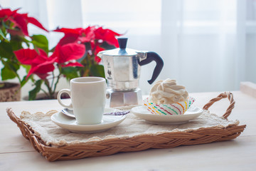 Breakfast with marshmallow or zephyr with a cup of coffee near Christmas poinsettia