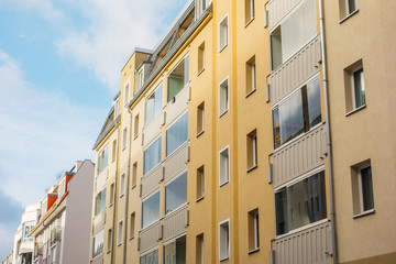Fototapeta na wymiar yellow apartment house with glassed balcony