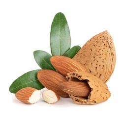 Group of almond nuts with leaves isolated on white background