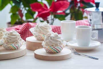Breakfast with marshmallow or zephyr with a cup of coffee near Christmas poinsettia