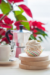 Breakfast with marshmallow or zephyr with a cup of coffee near Christmas poinsettia