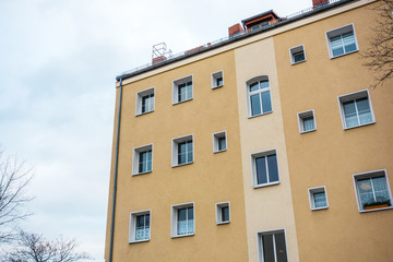 Fototapeta premium orange apartment building on a cloudy day