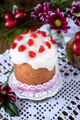 Easter cake on a white cloth surrounded by festive attributes