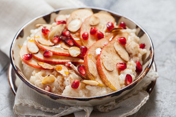 Coconut rice with pomegranate, pear and almond slices