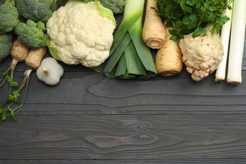 Fresh vegetables on dark wooden background. Mockup for menu or recipe. Top view with copy space