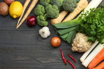 Fresh vegetables on dark wooden background. Mockup for menu or recipe. Top view with copy space