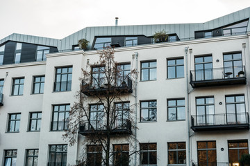 Fototapeta premium white modern apartment house with steel balcony