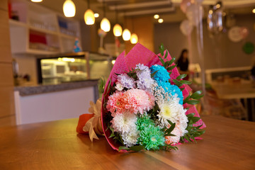 Colored birthday flower bouquet. Bouquet of colorful fresh freesia on a wooden background