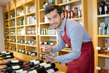 young man working in wine shop