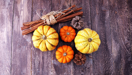 Obraz na płótnie Canvas Autumn Pumpkin Thanksgiving Background orange pumpkins over table.