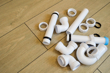 White plastic plumbing, plumbing pipes, smooth and curved, fittings, flanges, rubber gaskets....