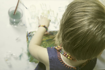 Naklejka premium Art in Child Development. Сute little girl learning to paint. Creativity, education, childhood concept.