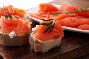 Bread with smoked salmon and cream cheese and herbs.