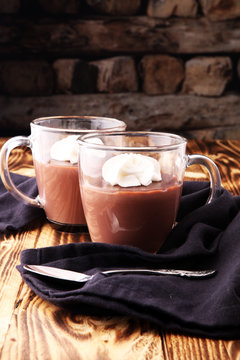 Hot chocolate or coffee with whipped cream in glass.