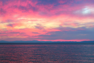 Colorful sunset over the crystal ice of Baikal lake
