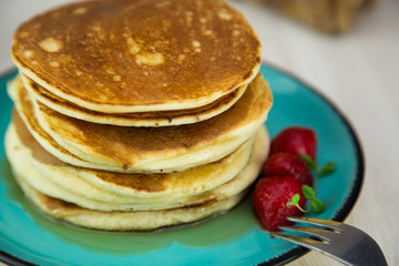 Close up breakfast pancakes with strawberries and mint