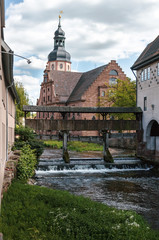Small river with a dike and a big church in Ettlingen, Germany