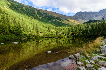 reflections in the lake water in the morning mist