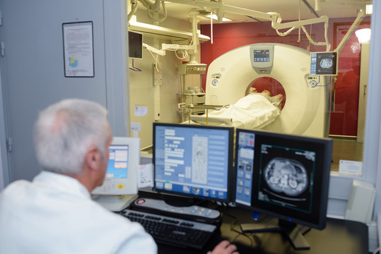 senior doctor checking a computerized axial tomography scan cat scan