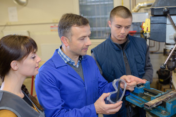 Fototapeta premium teacher explaining workers why wear protective equipment