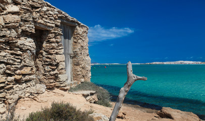 Formentera Ibiza. An old fishing garage on a crystal beach