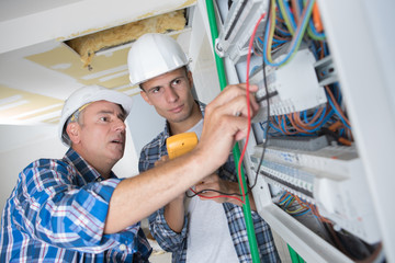 Trainee electrician learning to use multimeter