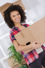 Young lady carrying cardboard box