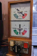 Old electronic semaphore signals in a railway signal box warning of the presence of a train