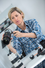 female photographer checking lens