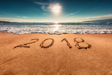 Happy New Year 2018 concept on the sea beach; sunrsie shot