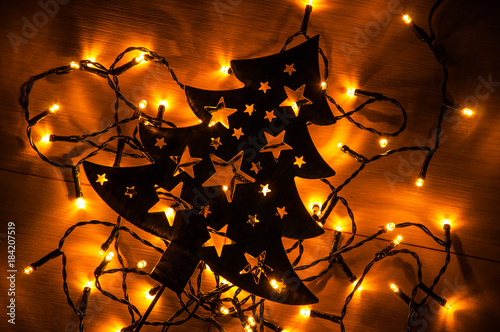 Black Christmas Tree On The Wooden Background With Small Yellow Lights Black Christmas Tree On The Wooden Background With Small Yellow Lights