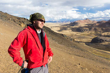 Tourist man adventurer backpacker standing mountain peak, Peru.