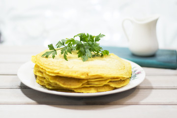 Salty pancakes with turmeric and parsley. Christmas background. Wooden background