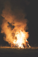 Fototapeta na wymiar Warm glow of a bonfire at night.