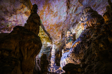 Postojna cave, Slovenia. Formations inside cave with stalactites and stalagmites. Low light image.