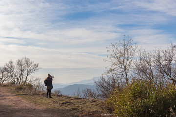 Woman photographing surreal landscape high in the mountains of Siurana, Spain