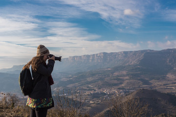 Woman photographing surreal landscape high in the mountains of Siurana, Spain