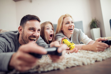 Happy family playing a video games at home
