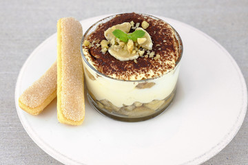 Tiramisu, traditional italian dssert on light background.