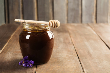 Buckwheat honey over wooden background