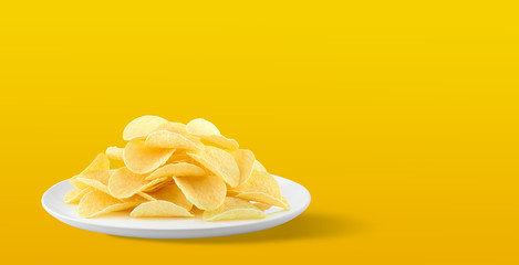 Potato chips in a plate on yellow background. with Copy space for your text.