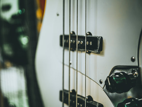 macro shot of four strings electric bass guitar