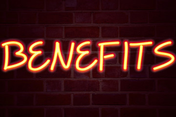 Benefits neon sign on brick wall background. Fluorescent Neon tube Sign on brickwork Business concept for Bonus Employee Financial Benefits 3D rendered