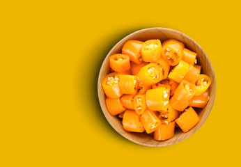 Chili slice in a cup on yellow background. with Copy space for your text.