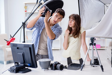 Young photographer working in photo studio