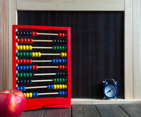 scores stand on the wooden table in front of chalkboard. study concept