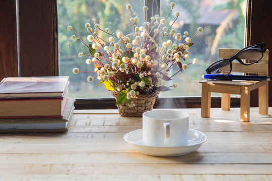 coffee   and   Flowers in a vase  on   wood table  in the morning
