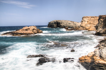 Fototapeta na wymiar The coastline with rocks on Antiparos, one of the Cyclade islands in Greece 