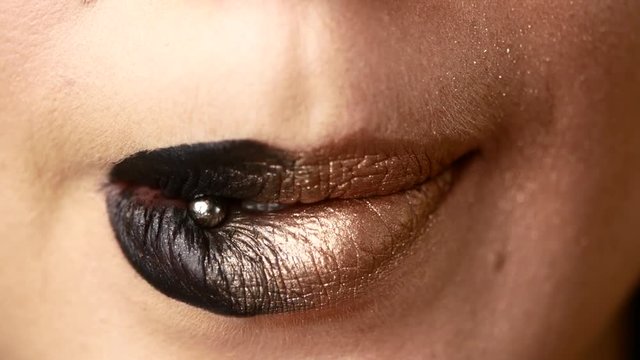 Beautiful and sexy female lips with expensive makeup. Close-up of painted female lips