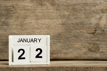 White block calendar present date 22 and month January on wood background